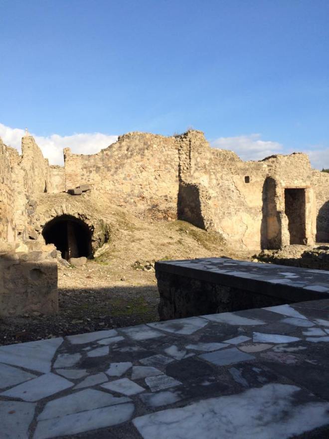 The remains of a bar and oven which were the equivalent of a restaurant. These types of "buildings" were scattered all along Pompeii.